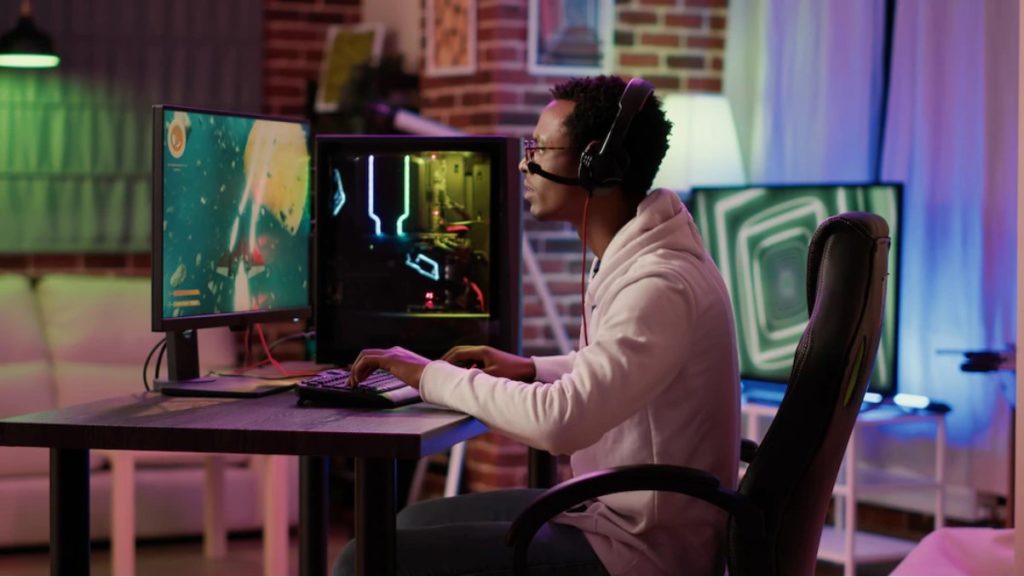 A man playing on his gaming desktop computer