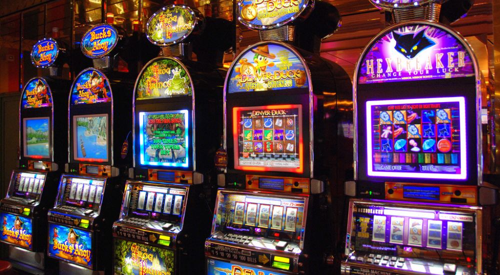 Five modern slot machines side by side.