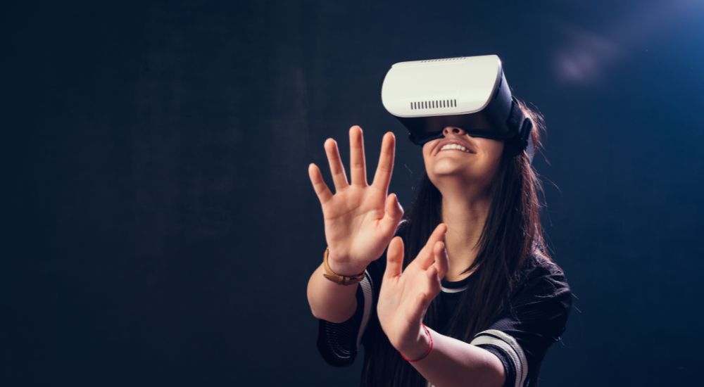 A girl playing with a VR glasses