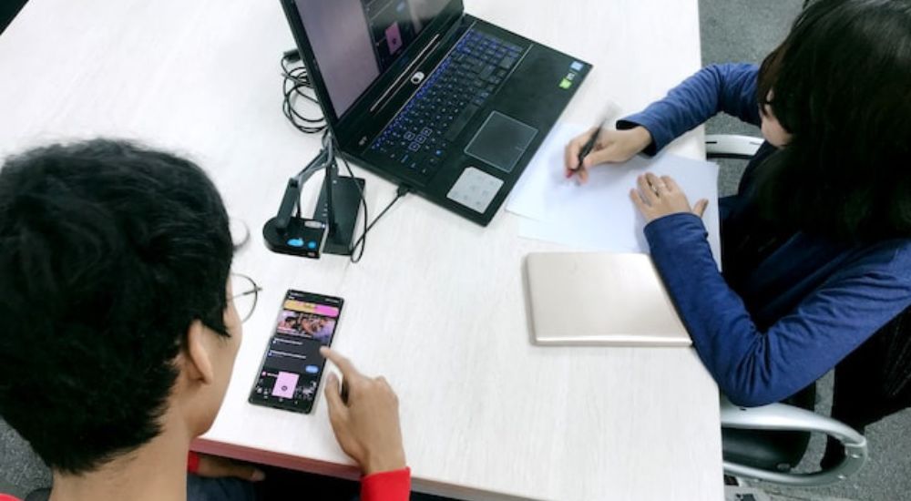 Two young people testing a game.