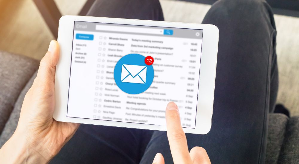 someone looking at emails on tablet