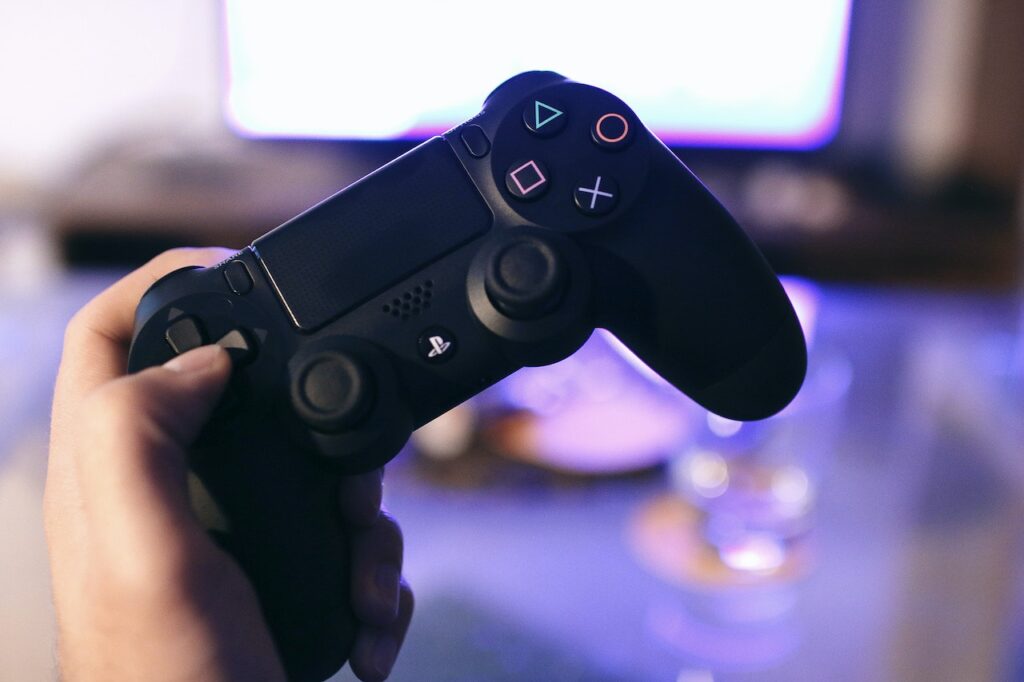Someone holding a PlayStation DualShock controller.