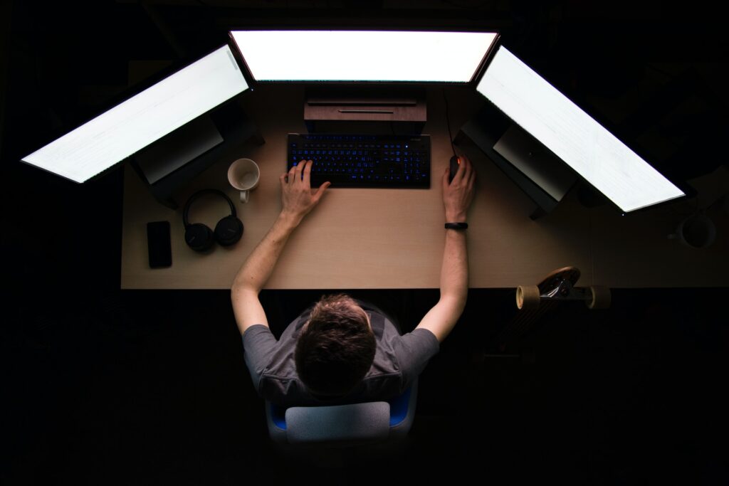 A man working on his computer at night.