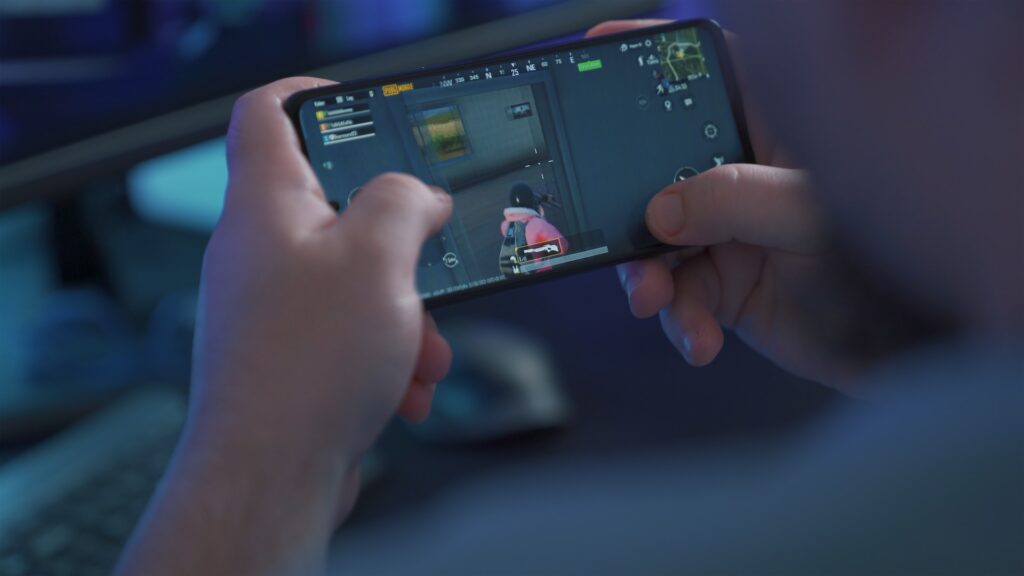 A person playing a shooter game on their phone.